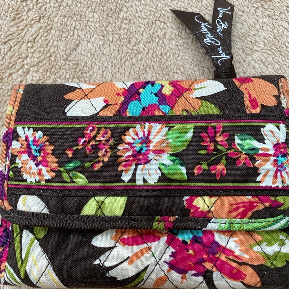 Gently used Vera Bradley tri-fold wallet. Holds eight credit cards and ID